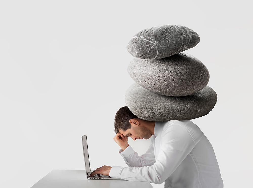 An image of a person under a lot of pressure and burden